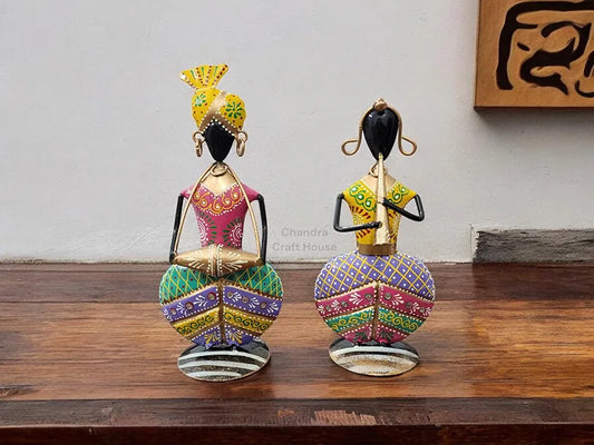 Two colorful figurines on a wooden surface with a neutral background