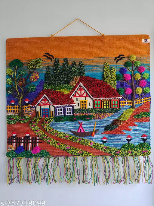 Colorful embroidered wall hanging with a village scene on an orange background