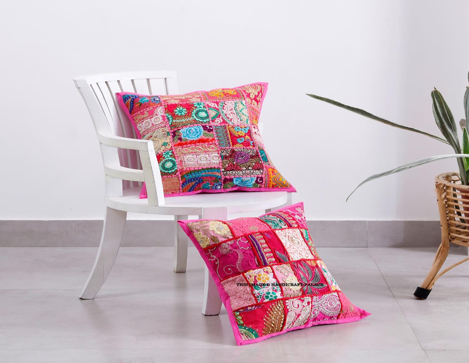 Handcrafted colorful patchwork cushion covers on a vintage wicker chair next to a white potted plant.