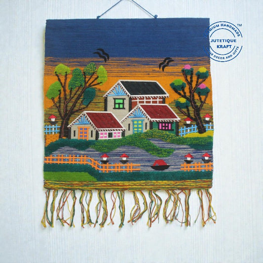 30x30 inch GI Tagged Jute Handwoven Wall Hanging showcasing an intricate Gramin village scenery design with a house and trees by Jutetique Kraft