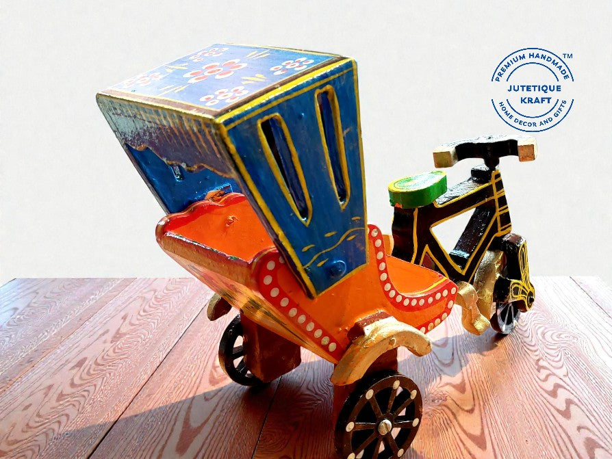 Close up of hand-painted traditional details and functional moving wheels on wooden cycle rickshaw miniature