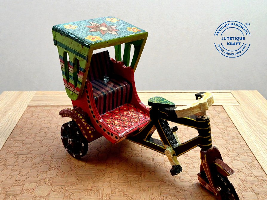 Close up of hand-painted traditional details and functional moving wheels on wooden cycle rickshaw miniature