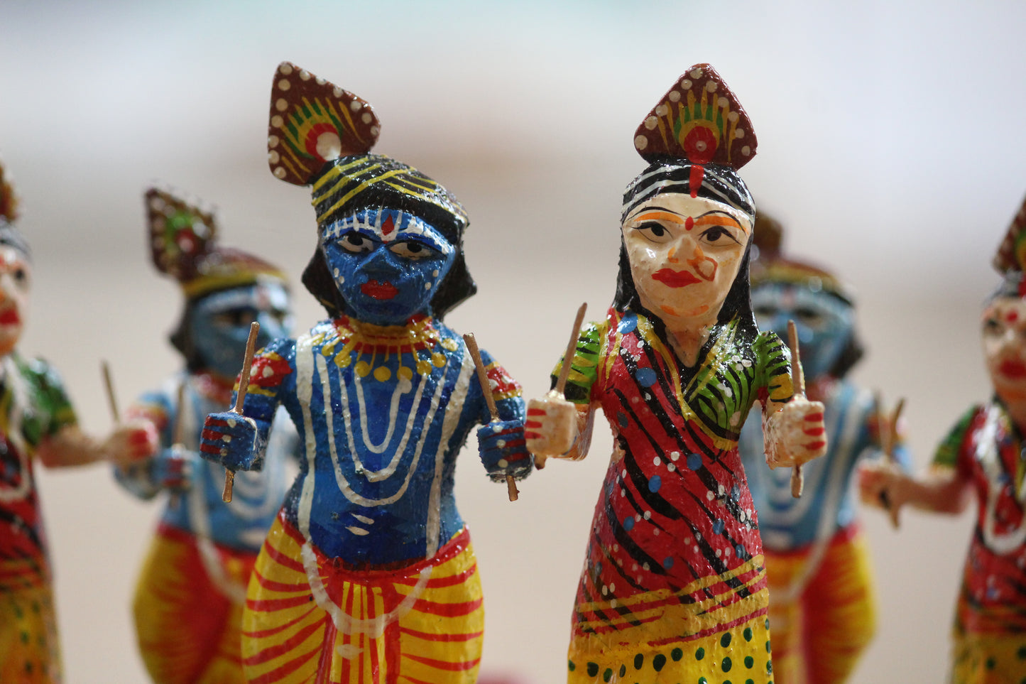 Intricate facial expressions and traditional attire detailing on handcrafted Varanasi lacquerware doll.