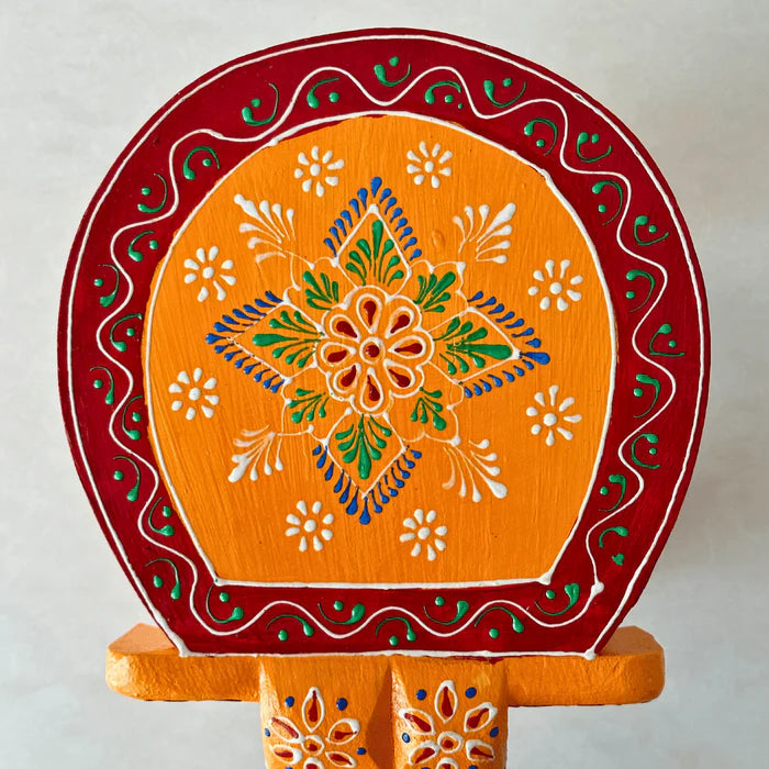 Handpainted orange wooden elephant stool with intricate traditional patterns by Jutetique Kraft