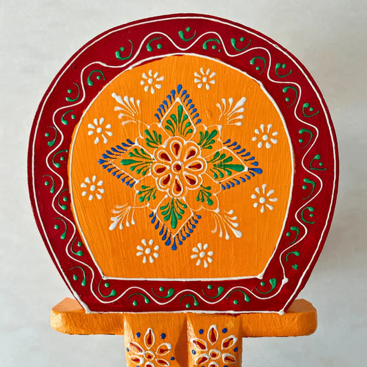 Handpainted orange wooden elephant stool with intricate traditional patterns by Jutetique Kraft