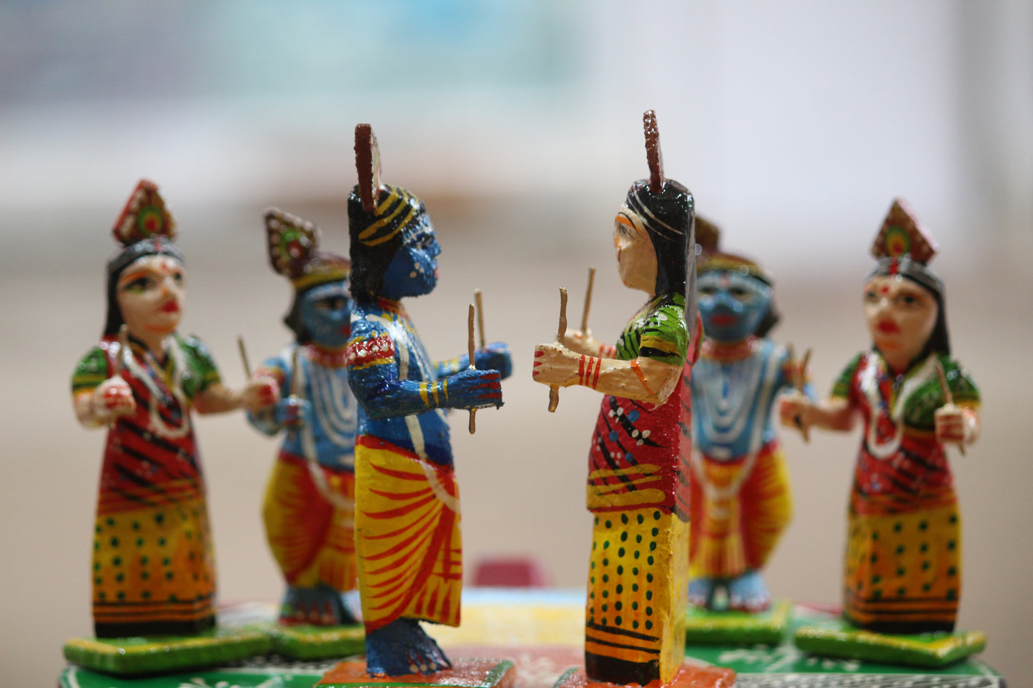 High-gloss friction-based lacquer finish on handmade Kashi wooden figurines by Kunder Kharadi artisans.