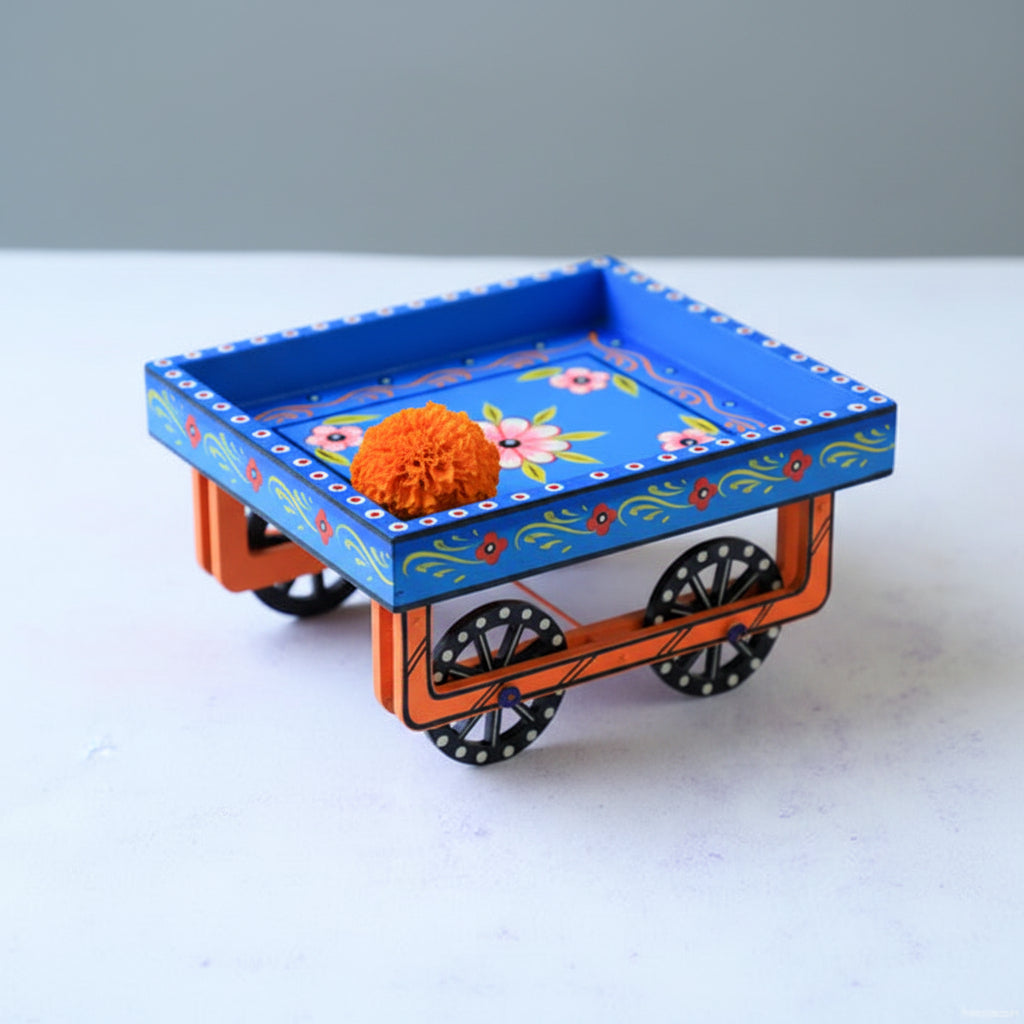 Colorful toy train with a blue platform featuring floral designs on a white surface.