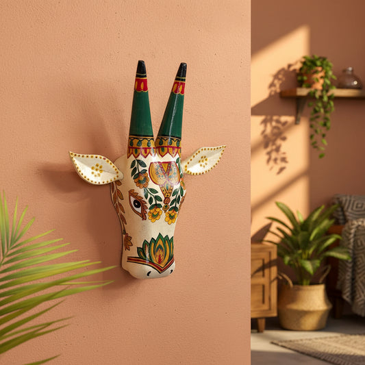 Hand-painted white wooden cow head wall decor featuring traditional Indian floral patterns and colorful horns.