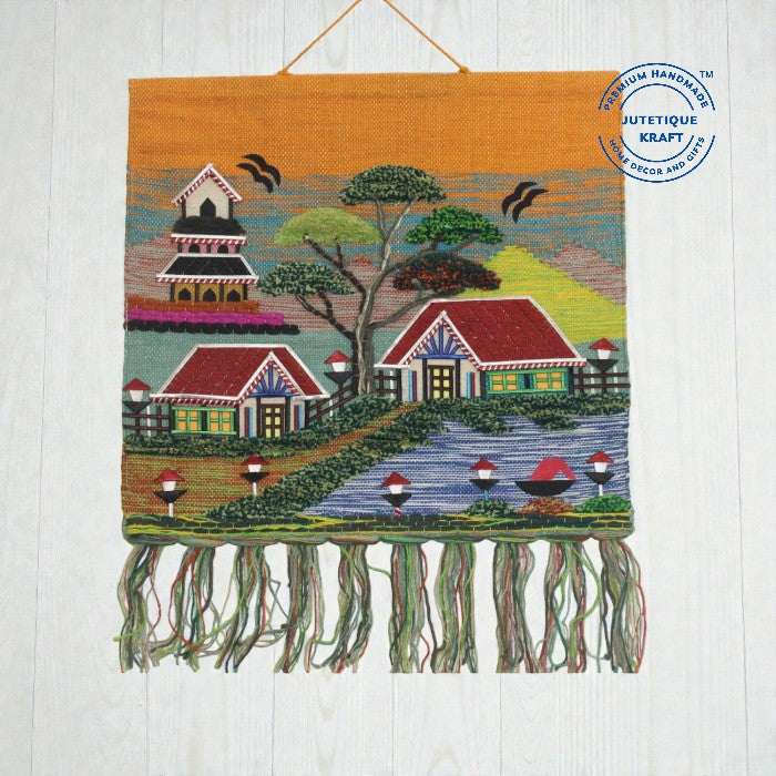 Handwoven Ghazipur jute landscape tapestry displaying a historic village temple scene under a warm orange horizon