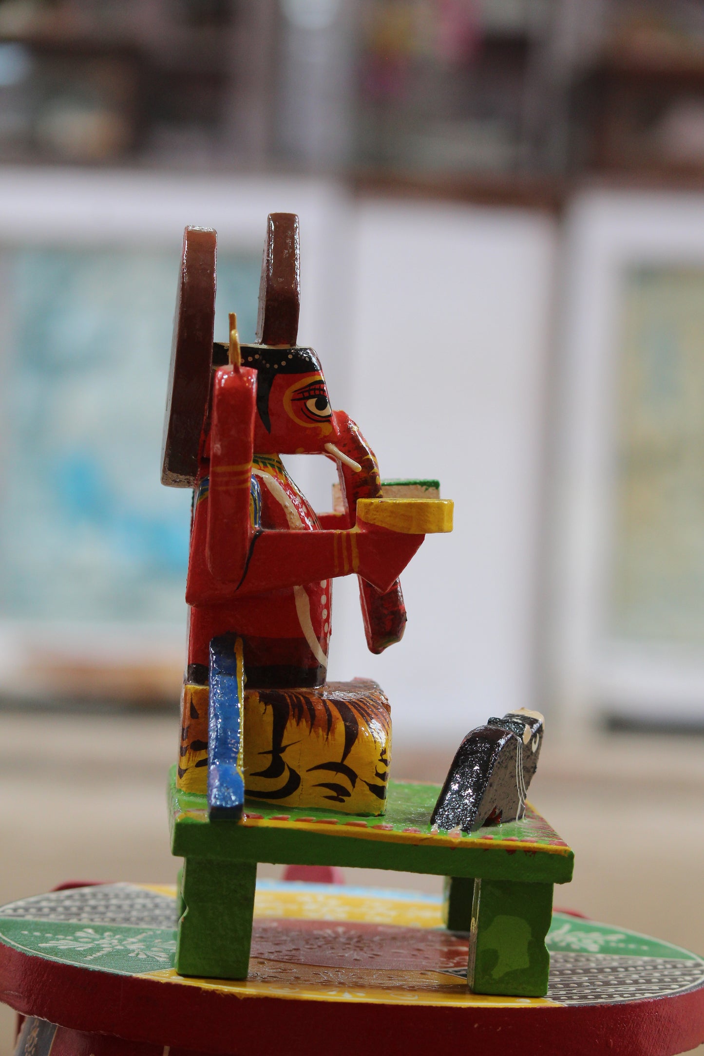 Side profile of eco-friendly handcrafted Varanasi lacquerware Ganpati figurine showcasing lathe craft.