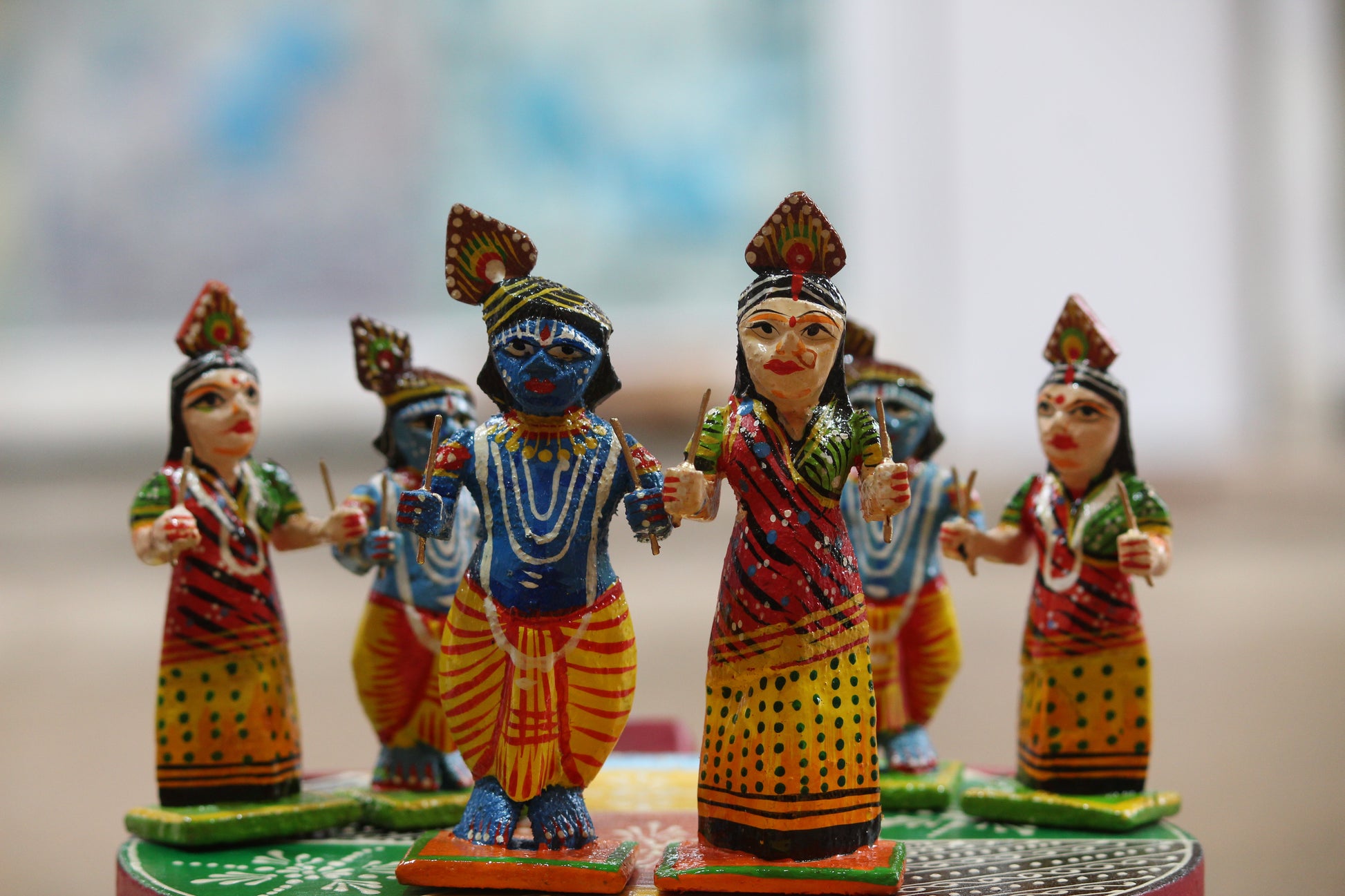Eco-friendly handcrafted spiritual home decor showcasing traditional Indian wooden Raas Leela figurines.