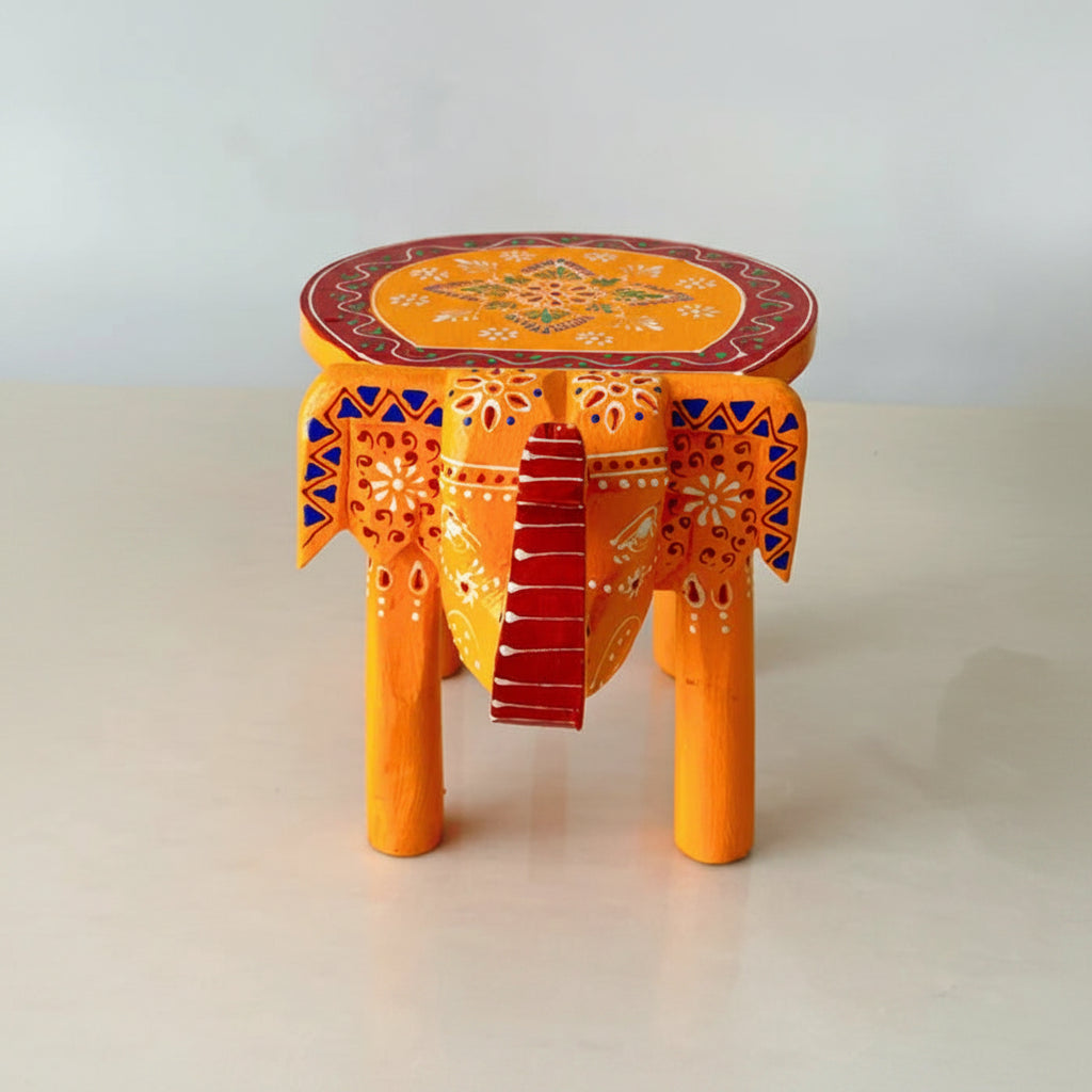 Handpainted orange wooden elephant stool with intricate traditional patterns by Jutetique Kraft.