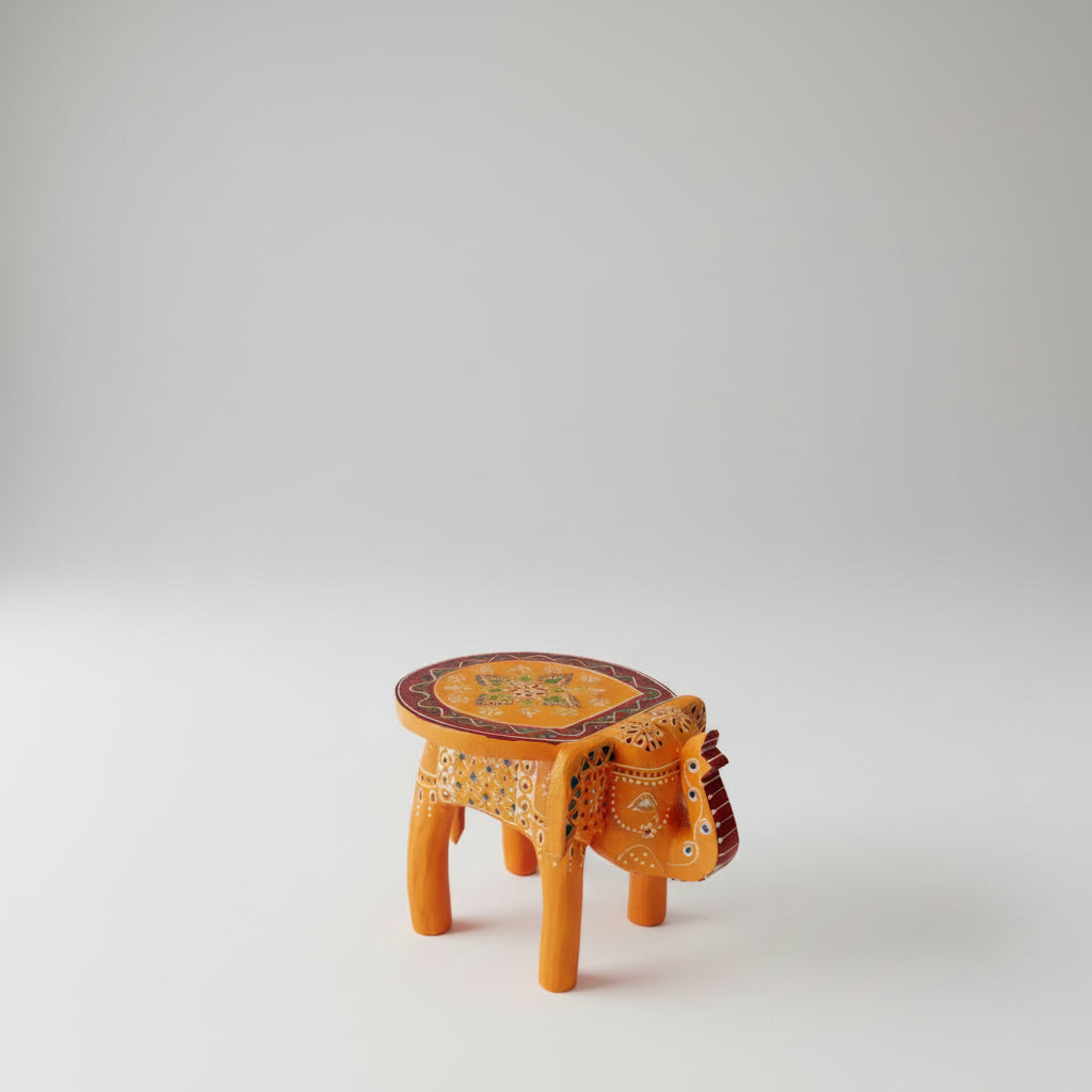 Handpainted orange wooden elephant stool with intricate traditional patterns by Jutetique Kraft.