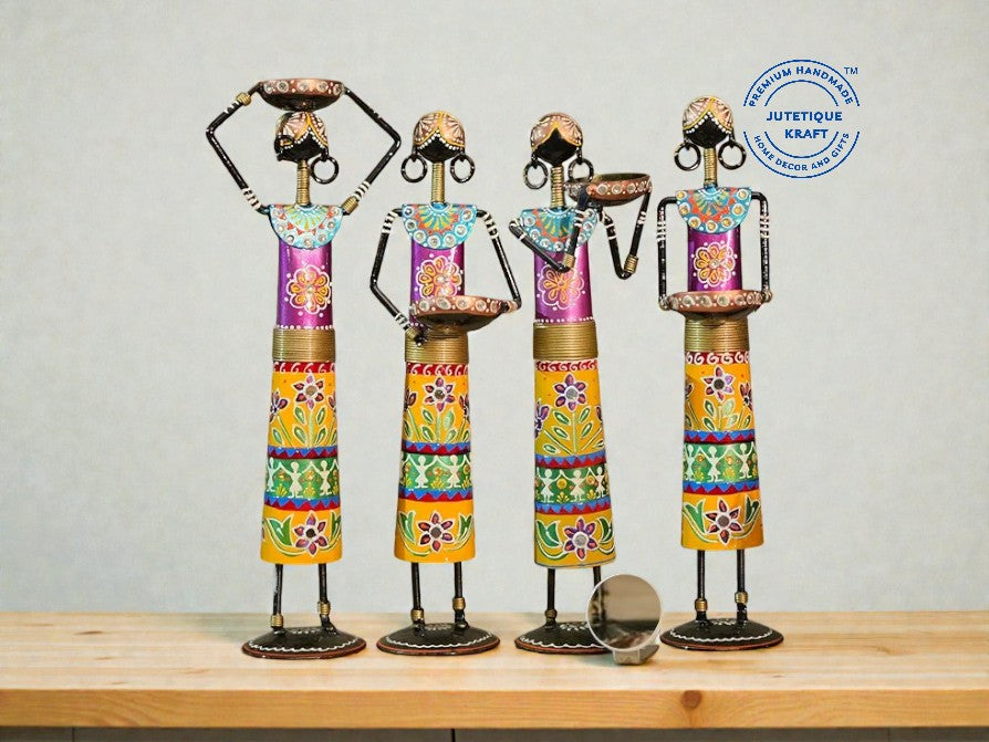 Colorful metal sculptures of people on a wooden surface with a gray background