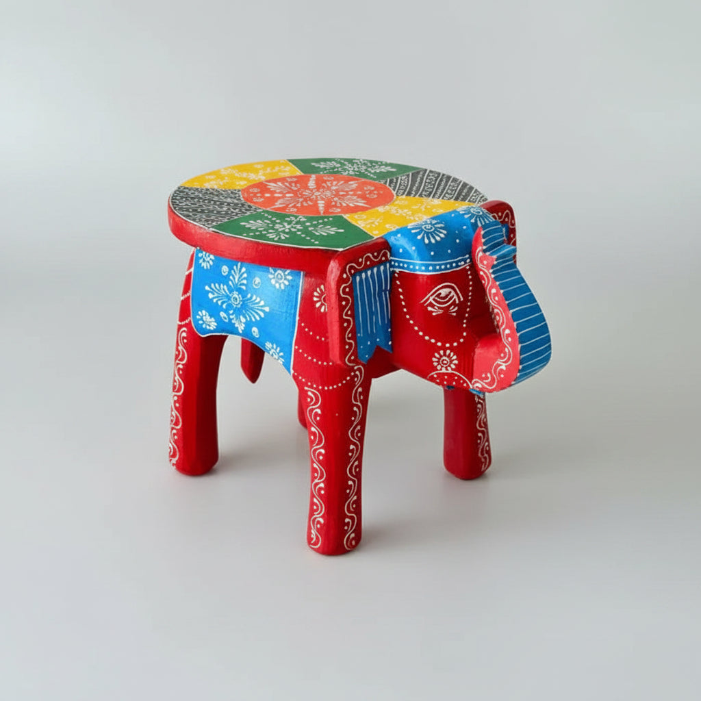 Handpainted red wooden elephant stool with vibrant blue and orange traditional motifs by Jutetique Kraft