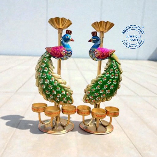Artisanal metal peacock candle holder figurines showing detailed traditional folk art patterns