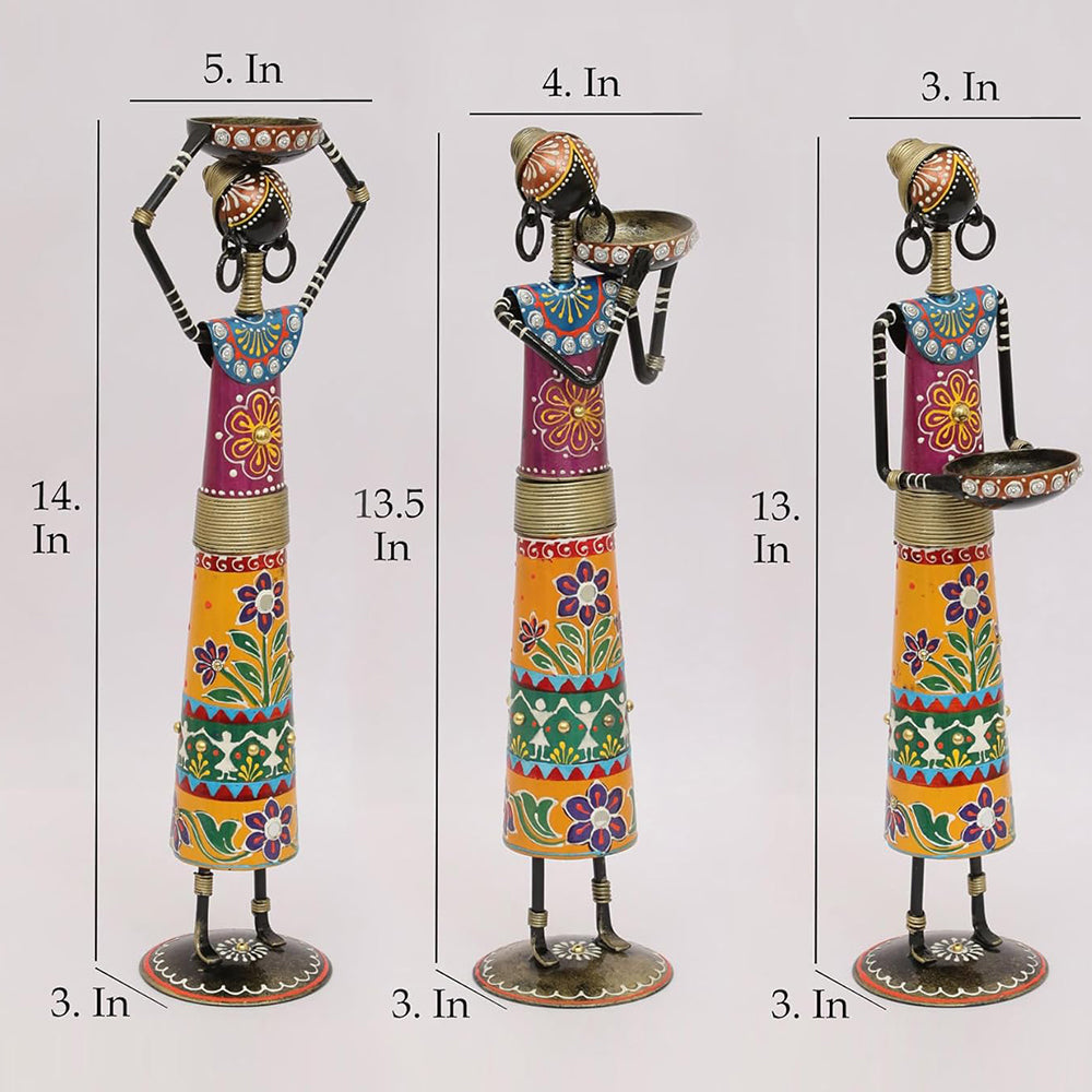 Three decorative figurines with varying heights on a white background