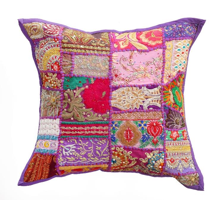 Multicolored patchwork pillow with intricate patterns on a white background