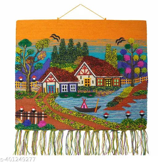 Handwoven Ghazipur jute wall hanging tapestry displaying a colorful village landscape scene with a small river pond and white fringes at the bottom