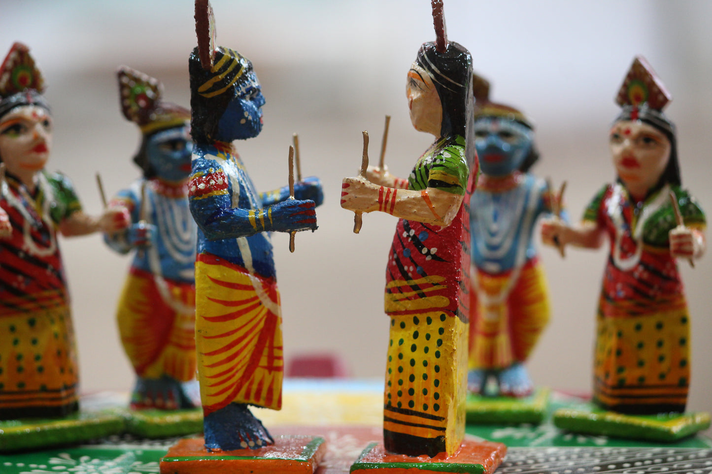 Vibrant multi-colored Banaras wooden toys set depicting the divine Raas Leela dance for festive display